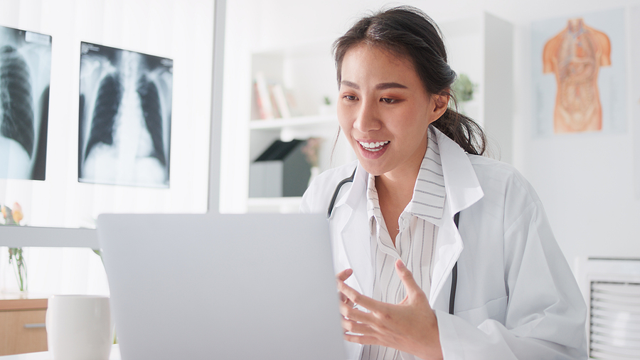 Healthcare scheduler working at her computer.