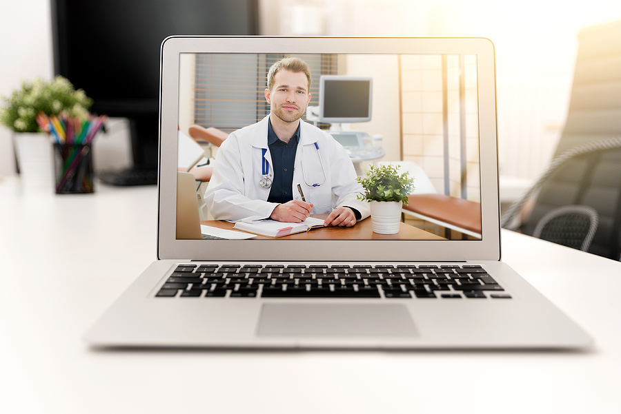 Male doctor on a laptop screen waiting for telehealth patient visit to begin.